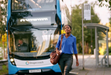 Woman walking in front of bus