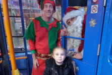 Santa and his elf with a young passenger