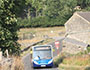 65 bus travelling through a peak district village
