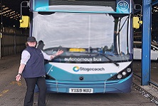 Abigail posing infront of autonomous bus