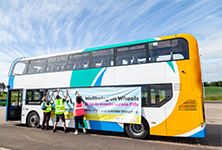 Stagecoach volunteers put up a banner on the Sam's Wellbeing on Wheels bus