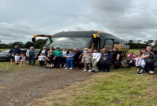 The Rotary Club of Buckhaven & Methil standing outside a Stagecoach Express coach