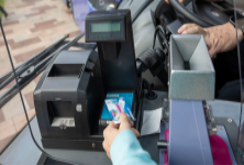 bus ticket being placed on a ticket machine