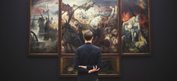 a man looking at a painting