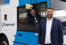 Christian Reed and David Watts by a Stagecoach bus 