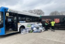 Two people stood by a Stagecoach bus and The Salvation Army van 