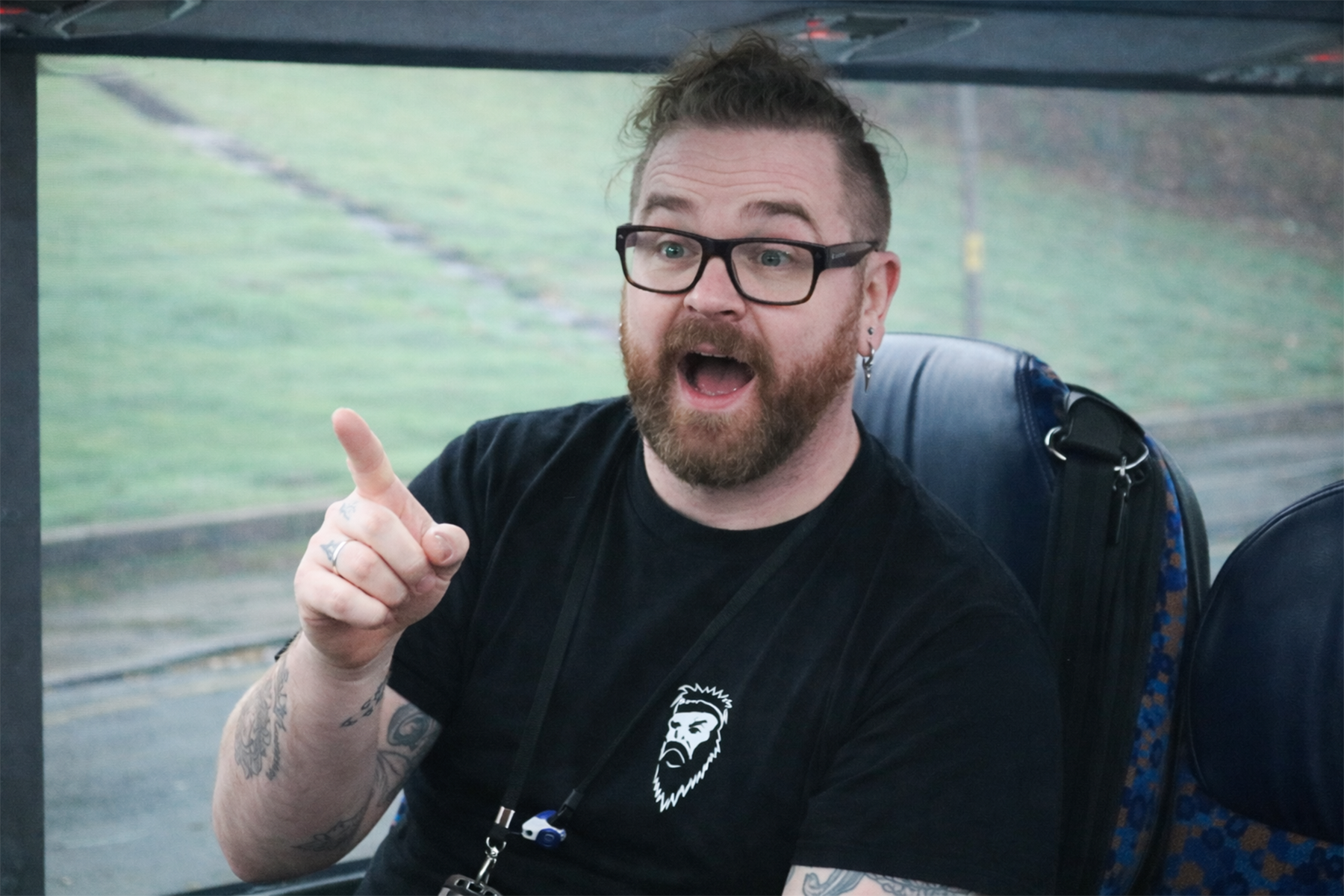 Comedian Billy Kirkwood centre stage on a Stagecoach bus entertaining customers