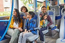 A photograph of a family on a bus