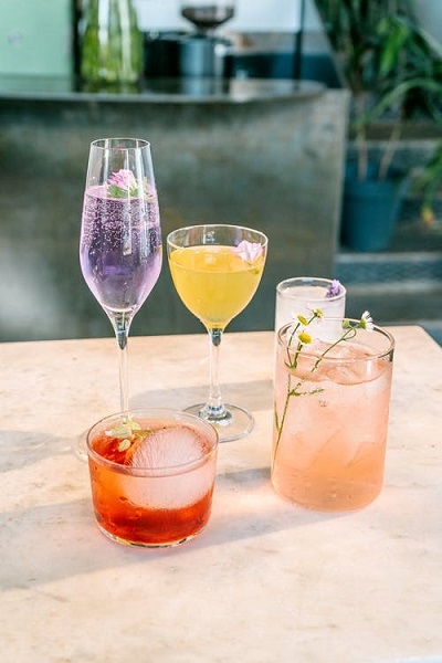 five cocktail glasses with different cocktails